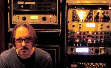 Butch Vig seated beside racks of recording equipment at Smart Studios.