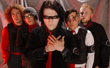 My Chemical Romance pose in red, black and white outfits, with Gerard Way at the centre, his hands crossed over his chest.