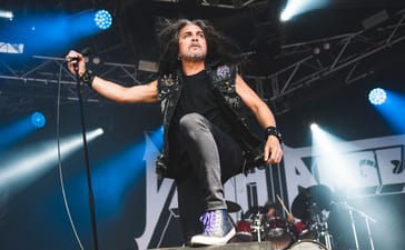 Mark Osegueda of Death Angel performs on stage at a festival