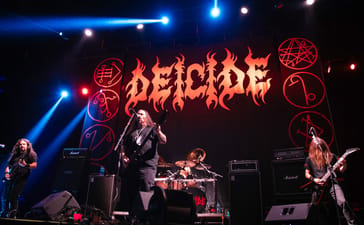 Deicide performing beneath a large band-logo backdrop at Showcenter in Monterrey, Mexico.