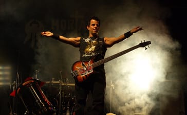 Mortal Sin bassist onstage with arms outstretched at Jalometalli festival in 2008.
