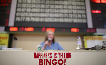 Bingo caller announcing numbers in a bingo hall