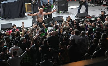 Haywire singer Austin Sparkman holds his arms out above the crowd at a Louisville concert.