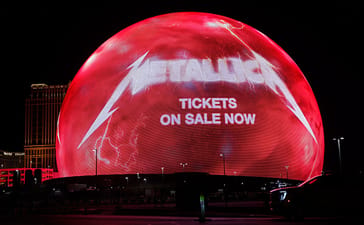Sphere in Las Vegas displays a red Metallica advertisement at night.