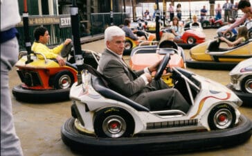 Leslie Nielsen sits in a bumper car during the 1988 Santa Monica, California, filming of the hit movie "The Naked Gun." (Photo by George Rose/Getty Images)