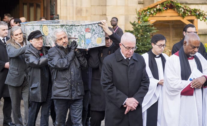 Ian Brown, Andrew Innes, Alan 'Reni' Wren and Liam Gallagher (front right) carry the coffin from the funeral service of former Stone Roses and Primal Scream bass player Gary Mounfield, who was known as Mani, at Manchester Cathedral, following his death at the age of 63. Picture date: Monday December 22, 2025. (Photo by Danny Lawson/PA Images via Getty Images)