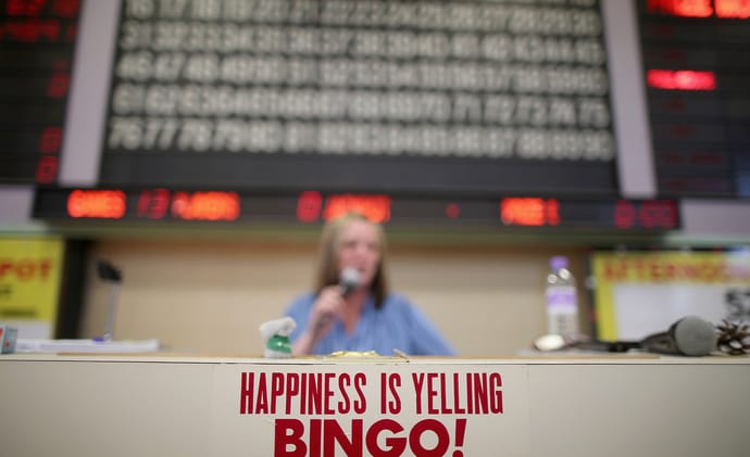 Bingo caller announcing numbers in a bingo hall
