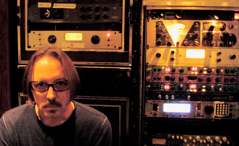Butch Vig seated beside racks of recording equipment at Smart Studios.