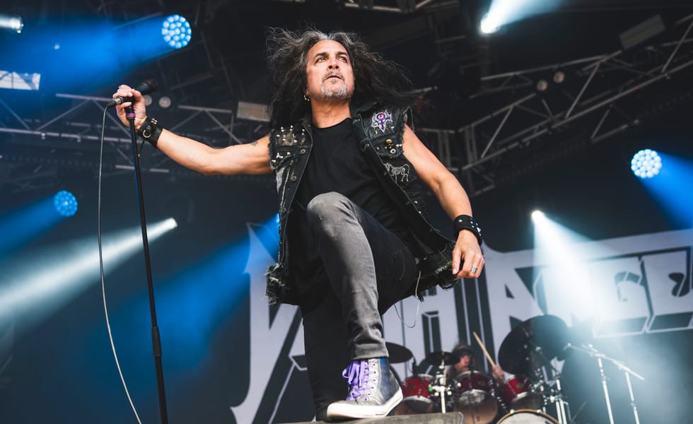Mark Osegueda of Death Angel performs on stage at a festival
