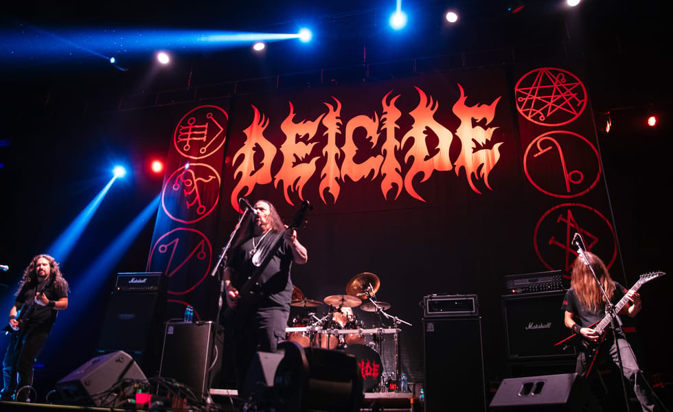 Deicide performing beneath a large band-logo backdrop at Showcenter in Monterrey, Mexico.