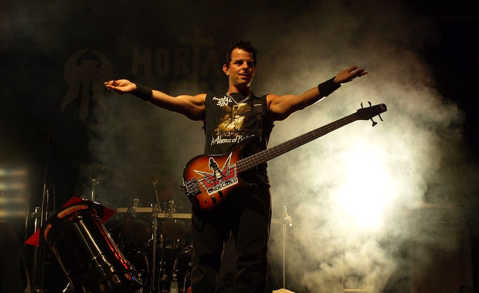 Mortal Sin bassist onstage with arms outstretched at Jalometalli festival in 2008.