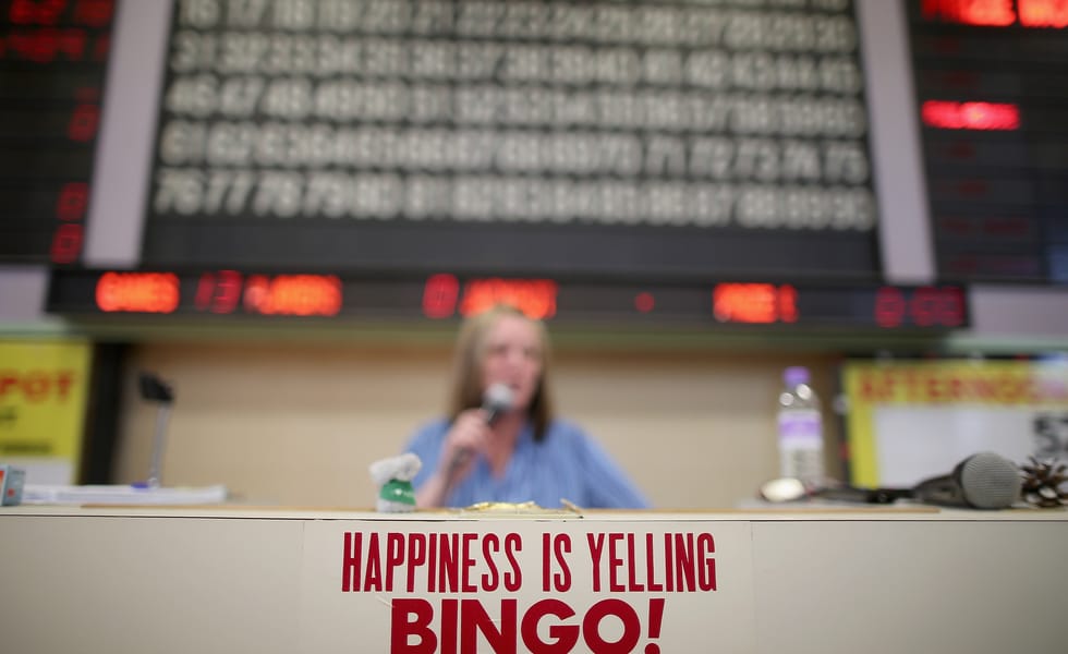 Bingo caller announcing numbers in a bingo hall