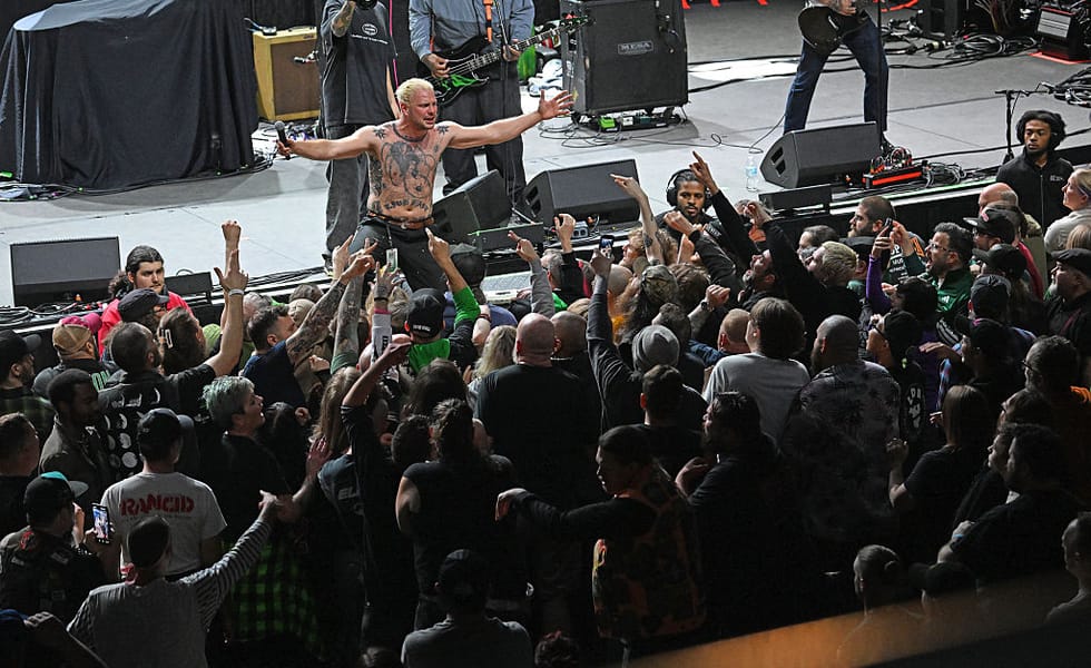 Haywire singer Austin Sparkman holds his arms out above the crowd at a Louisville concert.