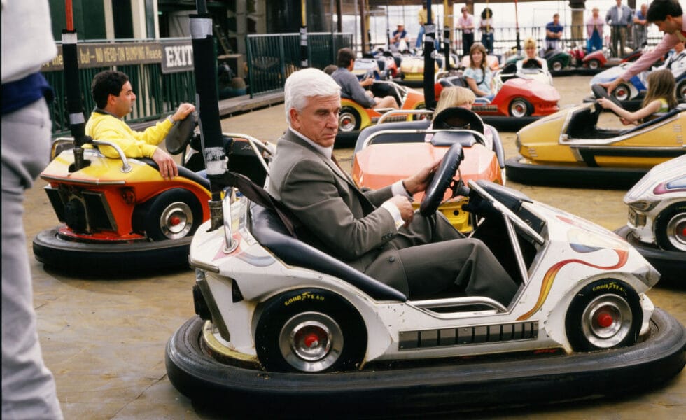 Leslie Nielsen sits in a bumper car during the 1988 Santa Monica, California, filming of the hit movie "The Naked Gun." (Photo by George Rose/Getty Images)