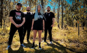 Bled Out band photo featuring the band members standing in the Australian bush