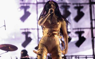 Poppy delivering an intense live set, blending industrial metal and pop chaos with her trademark icy stare