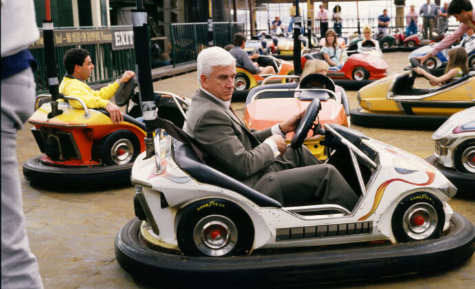 Leslie Nielsen sits in a bumper car during the 1988 Santa Monica, California, filming of the hit movie "The Naked Gun." (Photo by George Rose/Getty Images)